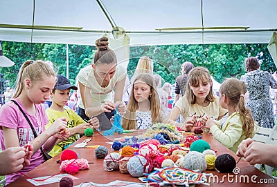 Outdoors children activity - knitting workshop Editorial Stock Photo